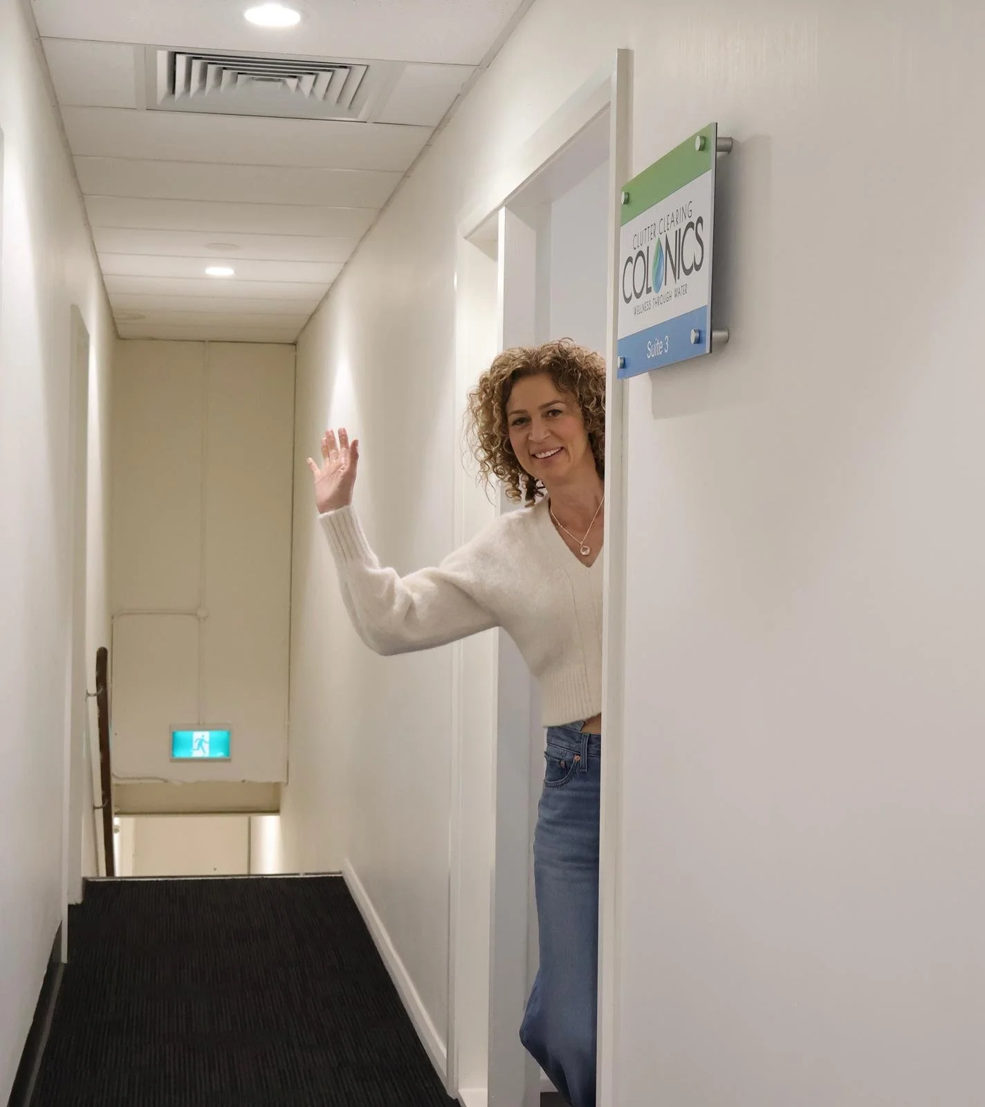 Sara waving at Clutter Clearing Colonics clinic Liverpool
